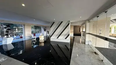 a large room with a lobby with glass walls at A069-Apt in residence with pool and sea view - Cannes in Cannes