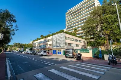 a street with cars parked on the side of a building at A069-Apt in residence with pool and sea view - Cannes in Cannes