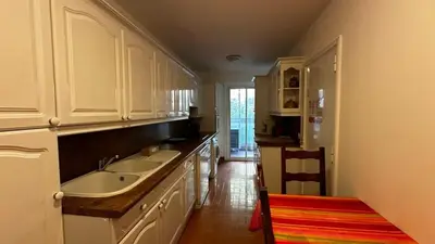 a kitchen with white cabinets and a sink at A069-Apt in residence with pool and sea view - Cannes in Cannes