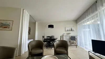 a living room with a table and a dining room at A050-Studio avec jardin prive Cannes pres de la plage in Cannes