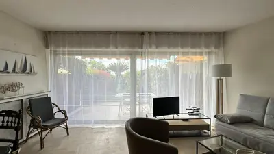 a living room with a couch and a table at A050-Studio avec jardin prive Cannes pres de la plage in Cannes