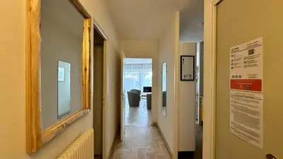 a hallway with a mirror on the wall and a hallway with a hallway at A050-Studio avec jardin prive Cannes pres de la plage in Cannes
