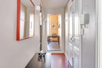 a hallway with a table and a mirror on the wall at A084-Welcoming apartment in Rue d'Antibes the heart of Cannes in Cannes