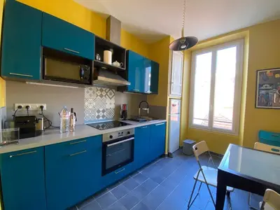 a kitchen with blue cabinets and a blue floor at A084-Welcoming apartment in Rue d'Antibes the heart of Cannes in Cannes
