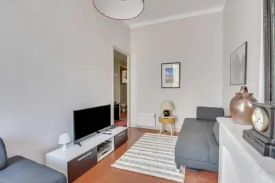 a living room with a couch and a tv at A084-Welcoming apartment in Rue d'Antibes the heart of Cannes in Cannes