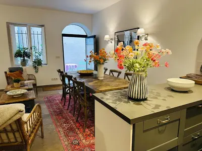 a kitchen with a table with a vase of flowers on it at B005-Charmant appartement au coeur du Suquet in Cannes