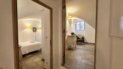 a view of a bedroom with a bed and a mirror at B005-Charmant appartement au coeur du Suquet in Cannes