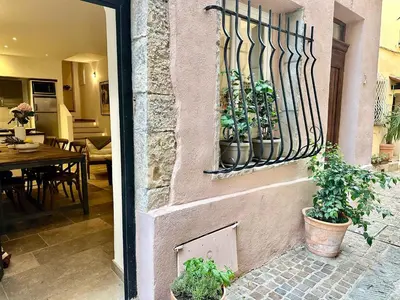 a house with plants in pots on a wall at B005-Charmant appartement au coeur du Suquet in Cannes