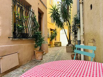 a table with a red and white checkered table cloth on a street at B005-Charmant appartement au coeur du Suquet in Cannes
