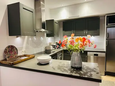 a kitchen with a vase of flowers on a counter at B005-Charmant appartement au coeur du Suquet in Cannes