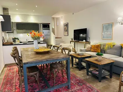 a living room with a table and a couch at B005-Charmant appartement au coeur du Suquet in Cannes
