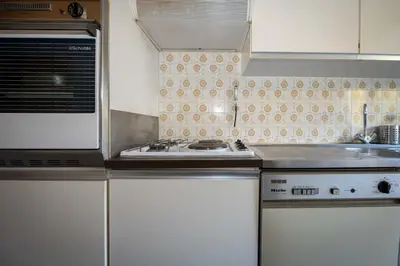 a kitchen with a stove and a sink at A081-Cannes Appartement avec terrasse au calme in Cannes