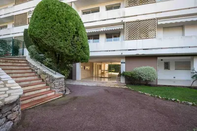 a building with a large bush in front of it at A081-Cannes Appartement avec terrasse au calme in Cannes