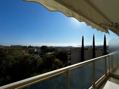 a balcony with a view of a city at A018-Large studio with sea view swimming pool garage in Cannes