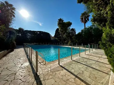 a swimming pool with a fence around it at A018-Large studio with sea view swimming pool garage in Cannes