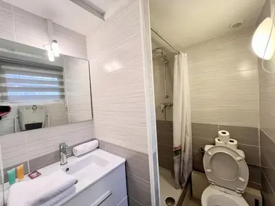 a bathroom with a sink and a toilet and a mirror at A043-Functional Studio Downtown Cannes in Cannes