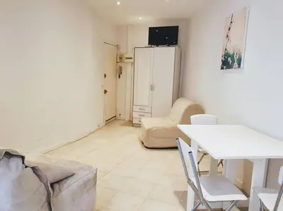 a living room with a couch and a table at A043-Functional Studio Downtown Cannes in Cannes