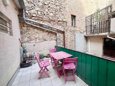 a pink table and chairs on a balcony at A043-Functional Studio Downtown Cannes in Cannes