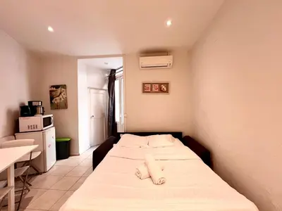 a small bedroom with a bed in a room at A043-Functional Studio Downtown Cannes in Cannes