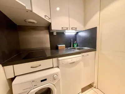 a small kitchen with a sink and a washing machine at A043-Functional Studio Downtown Cannes in Cannes