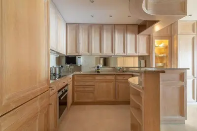 a kitchen with wooden cabinets and a counter top at C096-Apt overlooking the Old Port the view is magical in Cannes