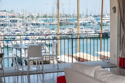 a room with a table and chairs and a marina at C096-Apt overlooking the Old Port the view is magical in Cannes