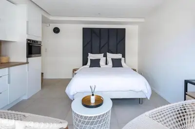 a bedroom with a bed and a table and chairs at B045-Studio croisette AC close Congress center SEA in Cannes
