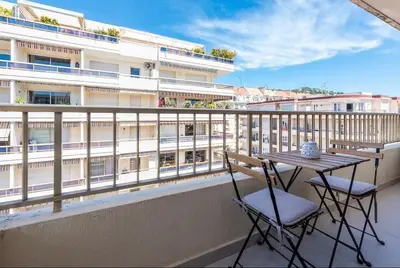 a balcony with a table and chairs and a building at B045-Studio croisette AC close Congress center SEA in Cannes