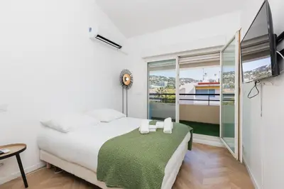 a living room with a couch and a table at L'exquis 800m plage et croisette in Cannes
