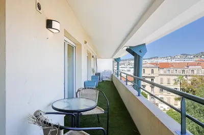 a red staircase leading up to a building with a sign at L'exquis 800m plage et croisette in Cannes