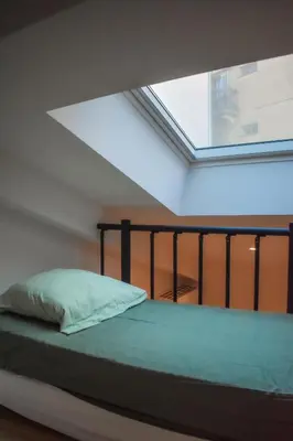 a bed in a room with a large window at STA5 Cannes, le suquet in Cannes