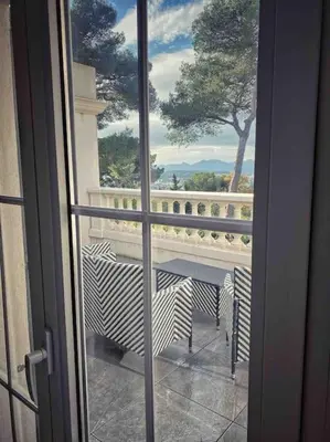 a view of a balcony from a sliding glass door at Villa Lion, gorgeous villa in Le Cannet overlooking Cannes in Le Cannet