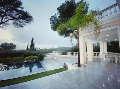 a villa with a swimming pool and a patio at Villa Lion, gorgeous villa in Le Cannet overlooking Cannes in Le Cannet