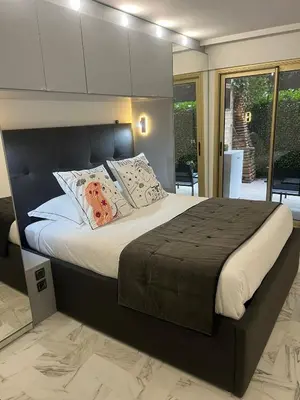 a bedroom with a large bed with pillows at Chic 47m2, 2 rooms, ground floor, nice patio, 280m beach Croisette in Cannes