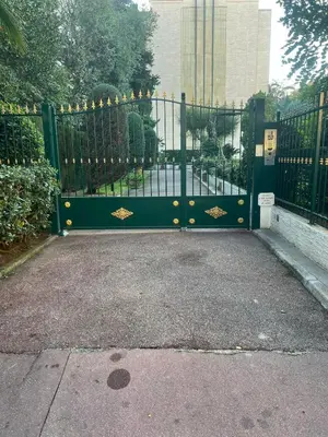 a black gate with gold decorations on it at Chic 47m2, 2 rooms, ground floor, nice patio, 280m beach Croisette in Cannes