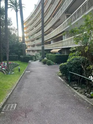 an empty street in front of a large building at Chic 47m2, 2 rooms, ground floor, nice patio, 280m beach Croisette in Cannes