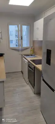 a kitchen with a sink and a refrigerator at Cannes carnot in Cannes