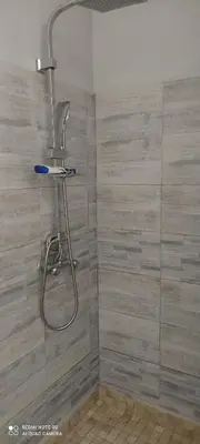 a shower with a shower head in a bathroom at Cannes carnot in Cannes
