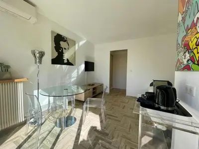 a glass table and chairs in a room at L'Olivier - Croisette Martinez, Studio sur cour, plage 1 min in Cannes