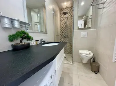 a bathroom with a sink and a toilet at L'Olivier - Croisette Martinez, Studio sur cour, plage 1 min in Cannes