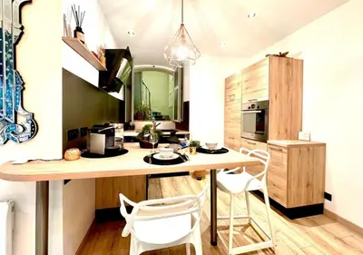 a kitchen with a large wooden table and white chairs at StudioCalifornia-Parking-Plages 15 min walk in Cannes