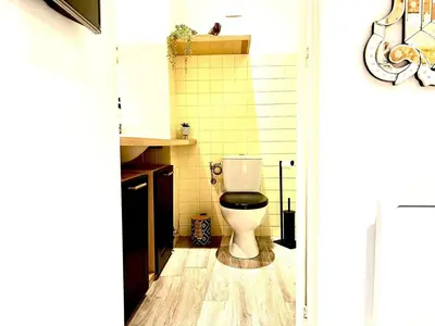 a bathroom with a toilet on a wooden floor at StudioCalifornia-Parking-Plages 15 min walk in Cannes