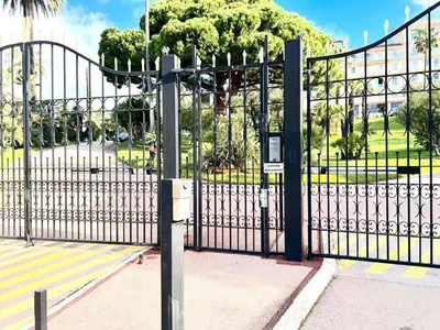 a black iron gate with a park behind it at StudioCalifornia-Parking-Plages 15 min walk in Cannes