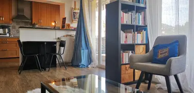 a living room with a blue couch and a table at Ref GALLIE in Cannes