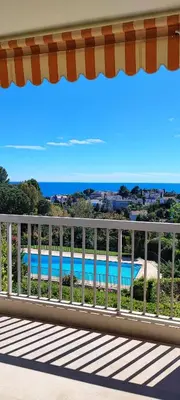 a balcony with a view of a swimming pool at MIPIM HORIZONS Executive Sea View Apartment 2 Bedrooms Terrace Pool Parking in Cannes
