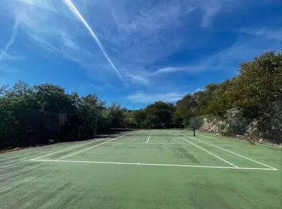 a tennis court with trees and a blue sky at MIPIM HORIZONS Executive Sea View Apartment 2 Bedrooms Terrace Pool Parking in Cannes