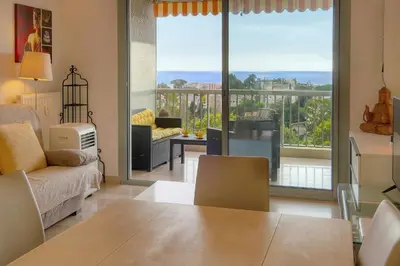 a living room with a view of the ocean at MIPIM HORIZONS Executive Sea View Apartment 2 Bedrooms Terrace Pool Parking in Cannes
