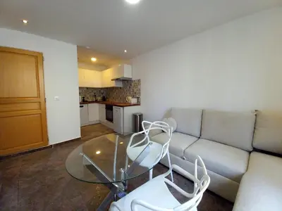 a living room with a couch and a glass table at Simon Apartments in Cannes