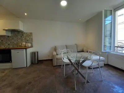 a living room with a table and a couch at Simon Apartments in Cannes