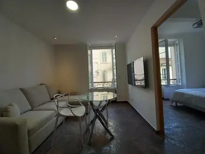 a living room with a couch and a glass table at Simon Apartments in Cannes
